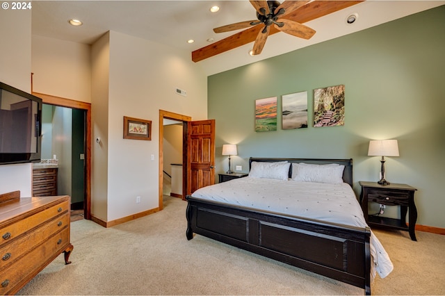 carpeted bedroom with ceiling fan and a high ceiling