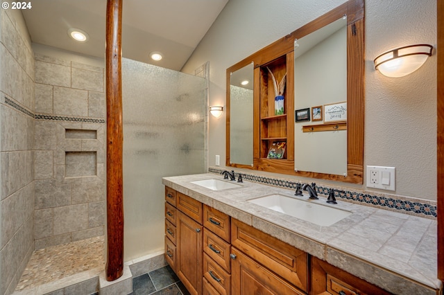 bathroom featuring vanity, a tile shower, and lofted ceiling