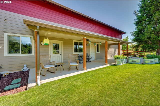 rear view of house featuring a yard and a patio