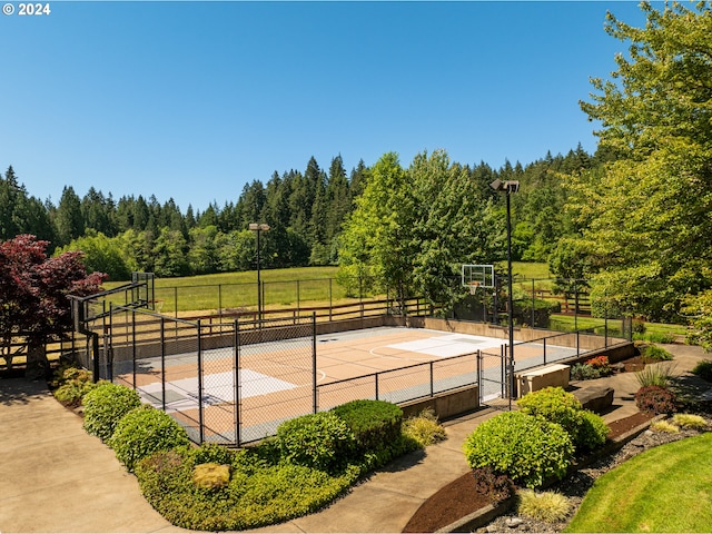 view of sport court with basketball hoop