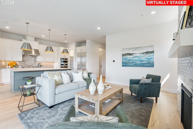 2784 N 49th Ave, Camas, WA 98607 - living room with light wood-type flooring, baseboards, a brick fireplace, and recessed lighting