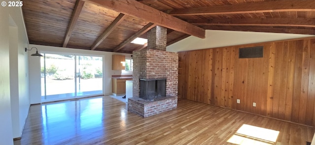 12950 SW 63rd Ave, Portland, OR 97219 - unfurnished living room with wood walls, wood finished floors, wood ceiling, and a brick fireplace