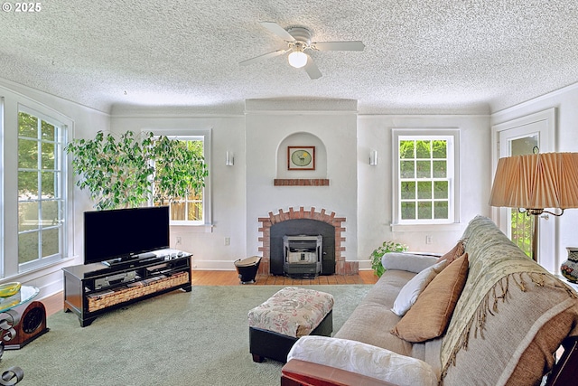 living room featuring ceiling fan, plenty of natural light, ornamental molding, and wood finished floors