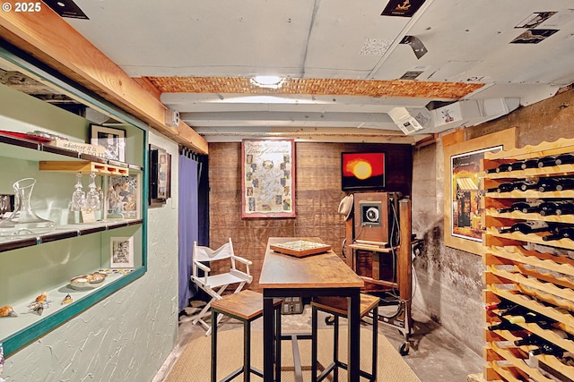 interior space with wood walls and unfinished concrete floors