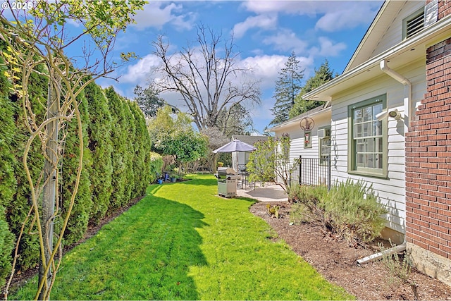 view of yard featuring fence and a patio area