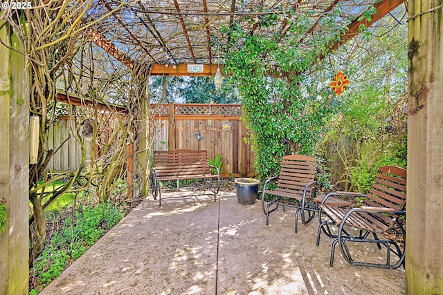 view of patio / terrace featuring a pergola and fence
