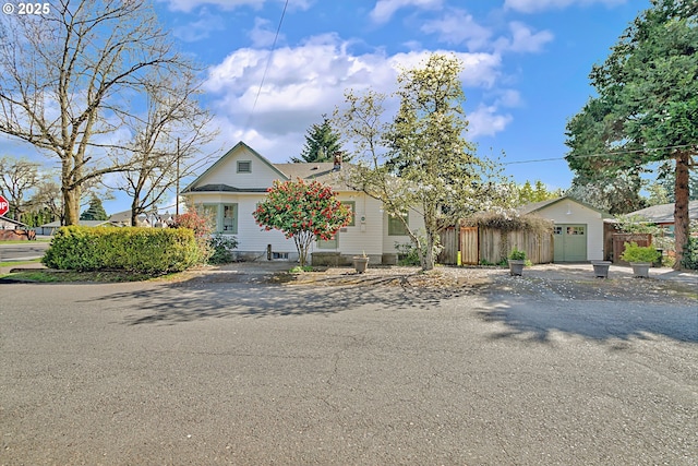bungalow-style house featuring fence and a chimney