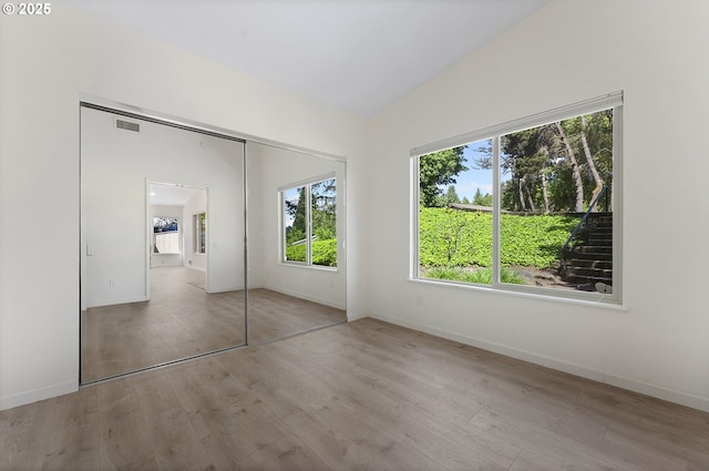 1397 Bonniebrae Dr, Lake Oswego, OR 97034 - unfurnished bedroom with multiple windows, wood finished floors, a closet, and baseboards