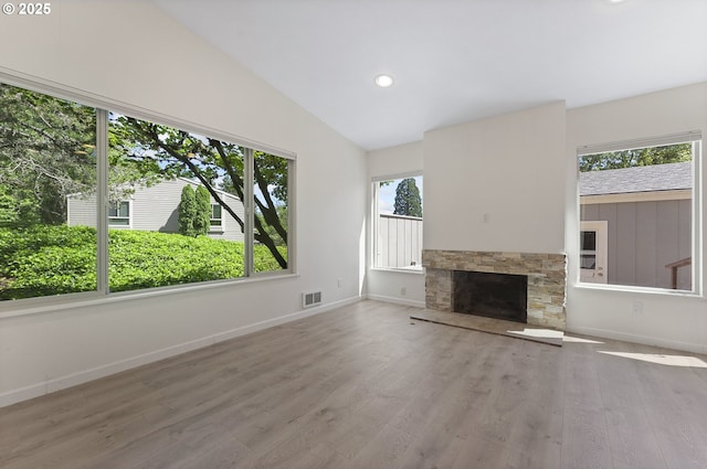 1397 Bonniebrae Dr, Lake Oswego, OR 97034 - unfurnished living room featuring wood finished floors, baseboards, lofted ceiling, a stone fireplace, and recessed lighting
