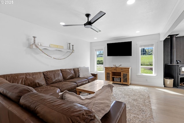 1069 Little Valley Rd, Roseburg, OR 97471 - living room featuring healthy amount of natural light, a wood stove, ceiling fan, recessed lighting, and wood finished floors