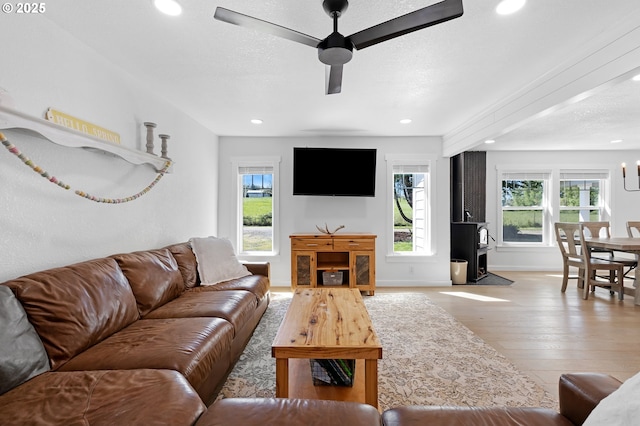 1069 Little Valley Rd, Roseburg, OR 97471 - living room with healthy amount of natural light, recessed lighting, wood-type flooring, a wood stove, and a ceiling fan