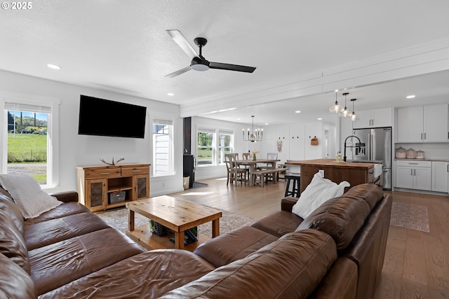 1069 Little Valley Rd, Roseburg, OR 97471 - living area featuring a chandelier, wood finished floors, a ceiling fan, plenty of natural light, and recessed lighting