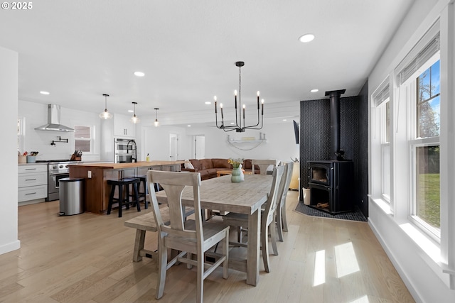 1069 Little Valley Rd, Roseburg, OR 97471 - dining room featuring light wood-type flooring, recessed lighting, a wood stove, and a chandelier