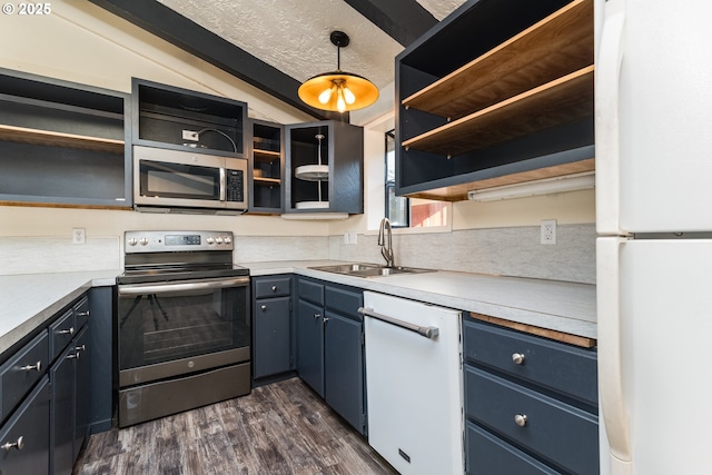 1260 Jackson Ave, Bandon, OR 97411 - kitchen with stainless steel appliances, open shelves, dark wood-style flooring, blue cabinets, and light countertops