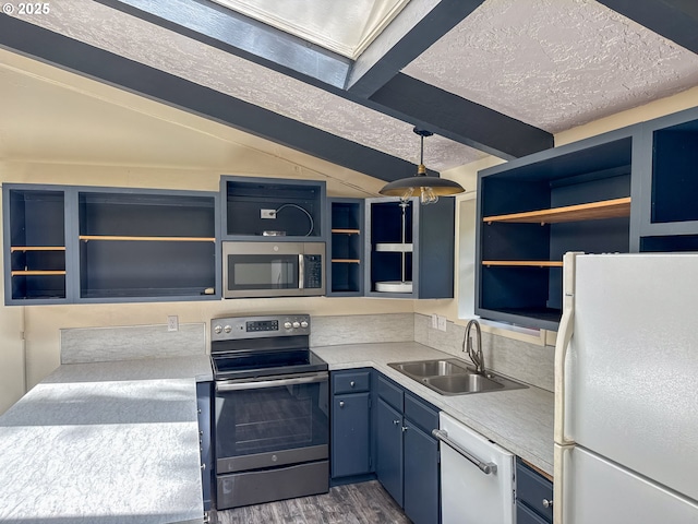 1260 Jackson Ave, Bandon, OR 97411 - kitchen featuring appliances with stainless steel finishes, open shelves, beam ceiling, light countertops, and dark wood finished floors