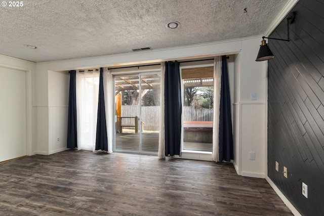 1260 Jackson Ave, Bandon, OR 97411 - unfurnished room with a textured ceiling and dark wood-type flooring