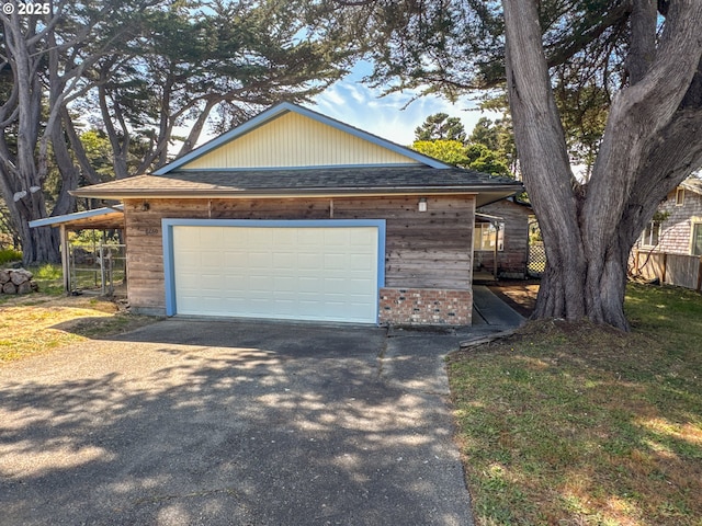 1260 Jackson Ave, Bandon, OR 97411 - garage featuring asphalt driveway