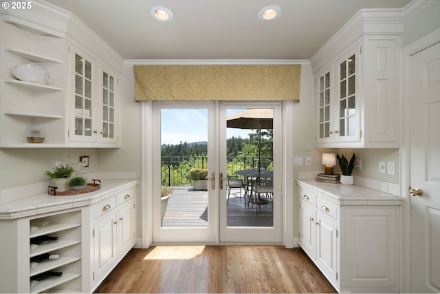 2892 NW Beuhla Vista Ter, Portland, OR 97210 - bar area with wood finished floors, ornamental molding, french doors, and recessed lighting