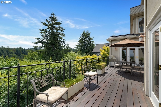 2892 NW Beuhla Vista Ter, Portland, OR 97210 - wooden terrace featuring outdoor dining space and a wooded view