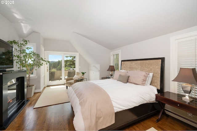 2892 NW Beuhla Vista Ter, Portland, OR 97210 - bedroom with access to exterior, lofted ceiling, wood finished floors, and a glass covered fireplace