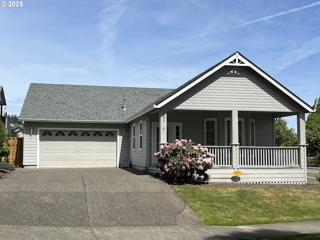 view of front of property with covered porch, driveway, a garage, a shingled roof, and a front lawn