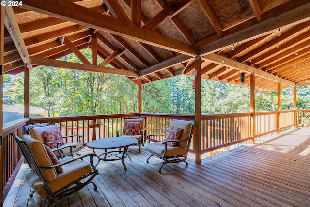 wooden terrace with a view of trees