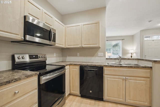 1639 SW 171st Ter, Beaverton, OR 97003 - kitchen with a sink, light wood-style floors, light brown cabinetry, and stainless steel appliances