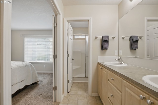 1639 SW 171st Ter, Beaverton, OR 97003 - full bathroom featuring baseboards, double vanity, a stall shower, a sink, and tile patterned flooring