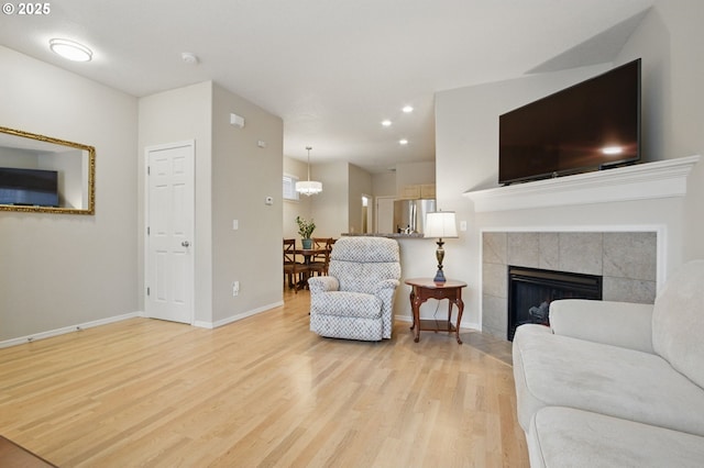 1639 SW 171st Ter, Beaverton, OR 97003 - living room with recessed lighting, light wood-style flooring, a fireplace, and baseboards