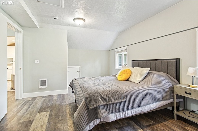 13616 SE Rhine St, Portland, OR 97236 - bedroom featuring wood finished floors, a textured ceiling, vaulted ceiling, heating unit, and baseboards