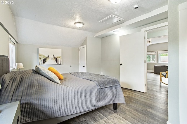 13616 SE Rhine St, Portland, OR 97236 - bedroom featuring attic access, wood finished floors, a textured ceiling, and vaulted ceiling