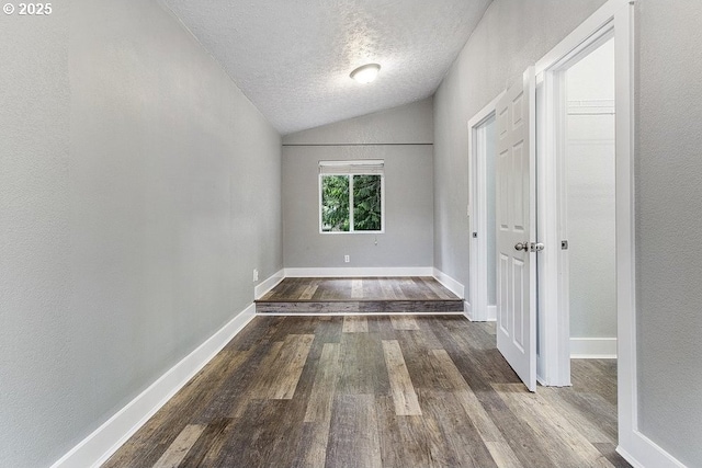 13616 SE Rhine St, Portland, OR 97236 - unfurnished room featuring wood finished floors, lofted ceiling, a textured ceiling, and baseboards