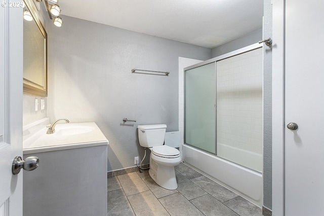 13616 SE Rhine St, Portland, OR 97236 - bathroom with toilet, vanity, shower / bath combination with glass door, tile patterned flooring, and a textured wall