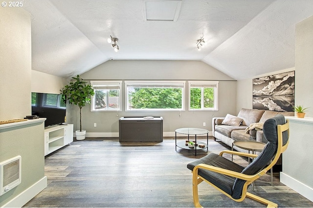 13616 SE Rhine St, Portland, OR 97236 - living area featuring plenty of natural light, baseboards, vaulted ceiling, heating unit, and wood finished floors