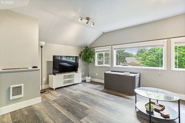 13616 SE Rhine St, Portland, OR 97236 - living room featuring heating unit, wood finished floors, baseboards, vaulted ceiling, and healthy amount of natural light