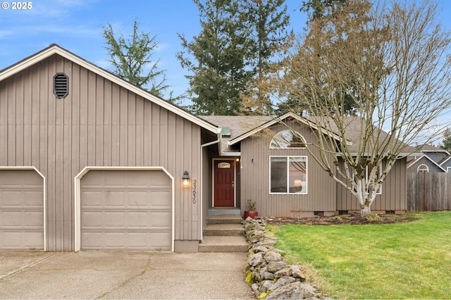 ranch-style home featuring a front lawn, fence, roof with shingles, a garage, and driveway