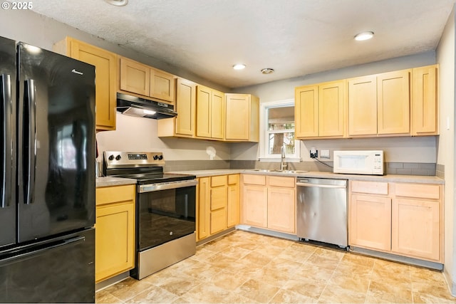 kitchen with under cabinet range hood, light brown cabinetry, light countertops, appliances with stainless steel finishes, and a sink