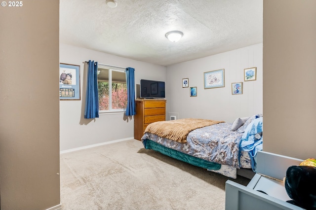 carpeted bedroom with baseboards and a textured ceiling