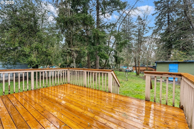 wooden deck featuring a yard and fence