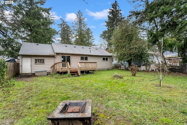 rear view of property with a yard, a fenced backyard, a chimney, and a wooden deck