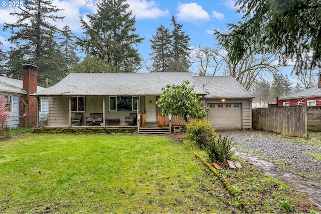 single story home with an attached garage, gravel driveway, a front lawn, and fence