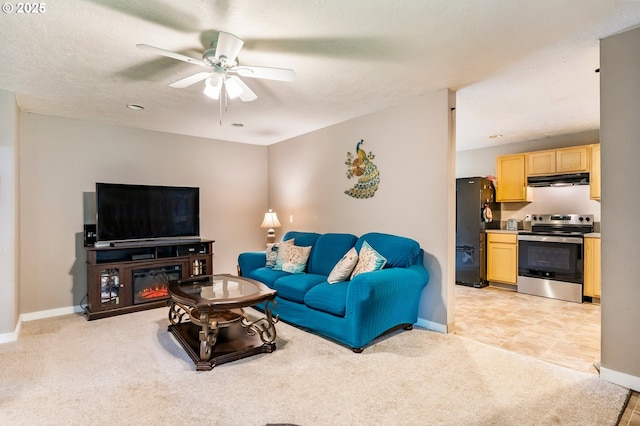 living area with a ceiling fan, light colored carpet, and baseboards