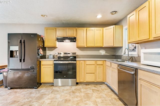 kitchen featuring under cabinet range hood, light brown cabinets, and appliances with stainless steel finishes