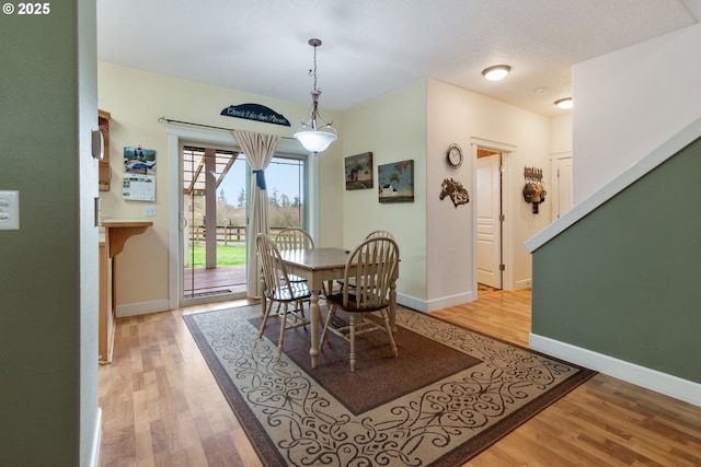 dining room featuring baseboards and light wood-style floors