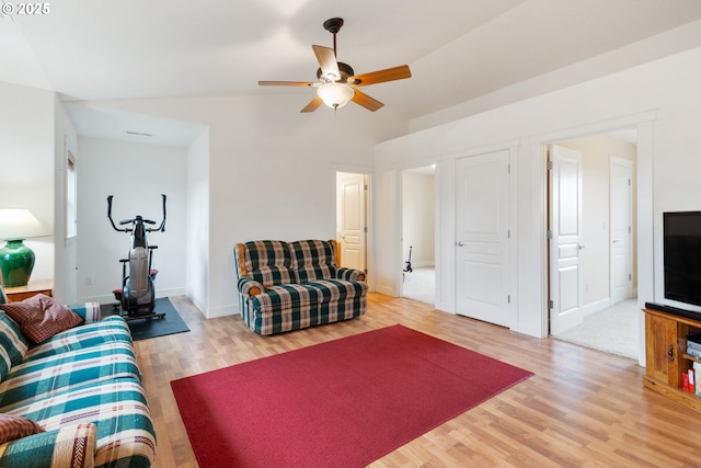 living area with wood finished floors, baseboards, and ceiling fan