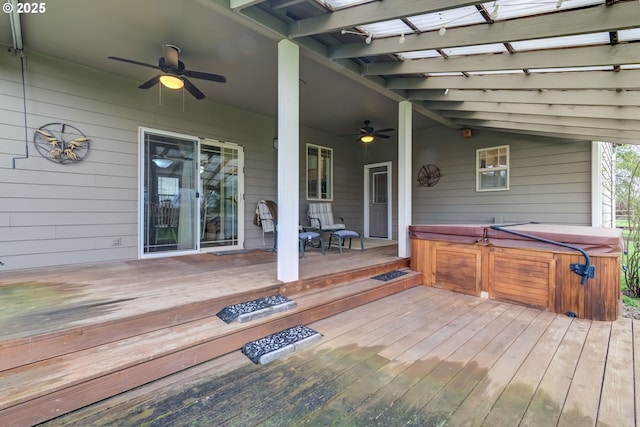 wooden deck featuring a hot tub and ceiling fan