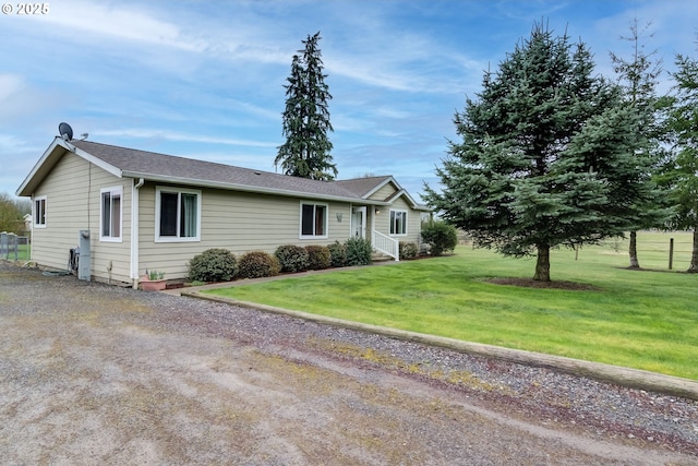 ranch-style home featuring a front lawn