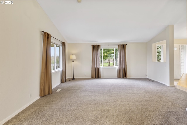 unfurnished room with baseboards, carpet, and vaulted ceiling