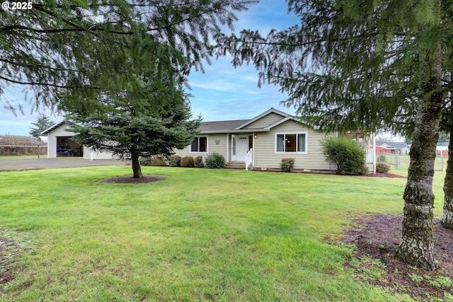 ranch-style house with aphalt driveway, an attached garage, a front yard, and fence