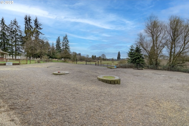 view of yard featuring a rural view and fence